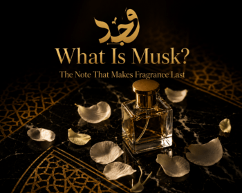 musk fragrance crystal bottle with white petals on dark marble