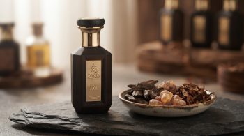 Science of fragrance longevity: WAJD LAYL Night Oud Extrait de Parfum on slate with oud wood chips and amber resin