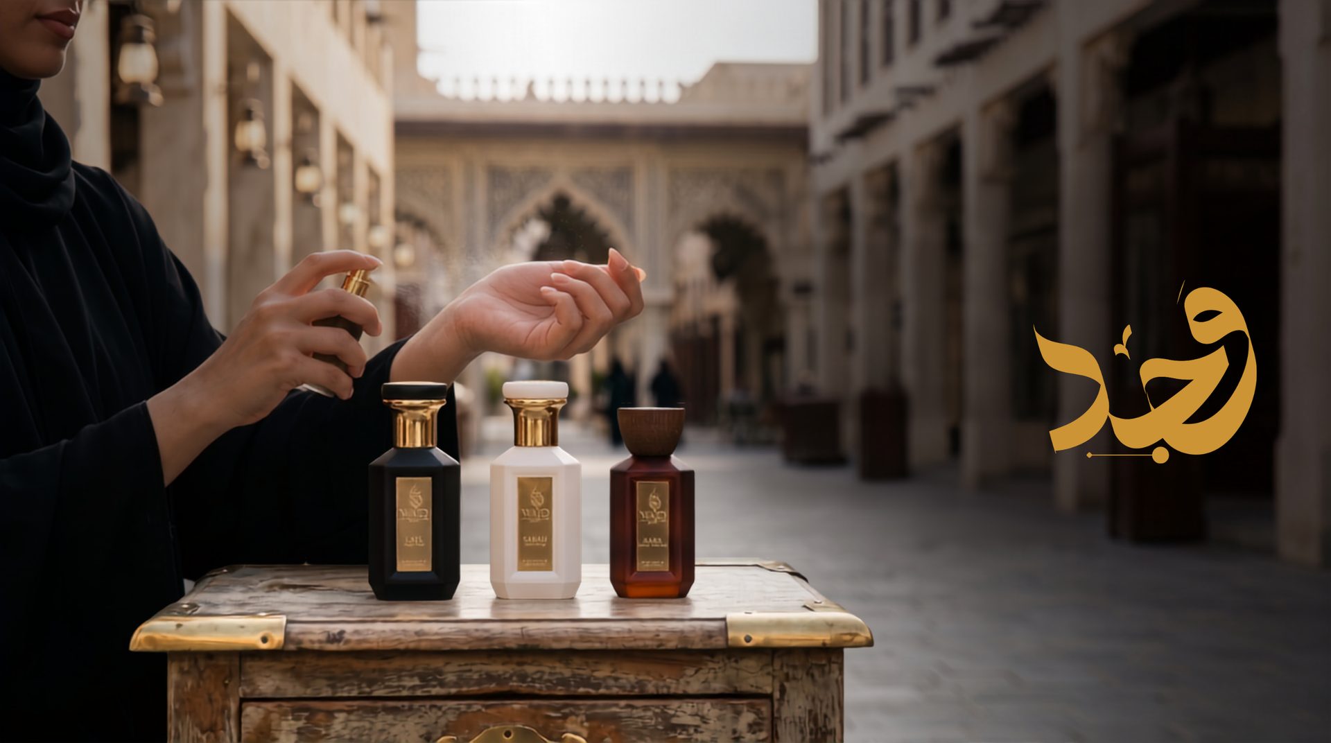 Why perfume fades faster in Qatar: woman applying perfume to her wrist in a Doha souq beside WAJD LAYL, SABAH and BARR